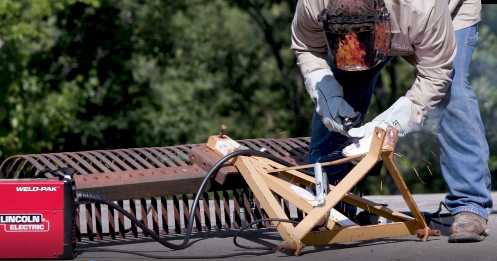 Person welding in the woods