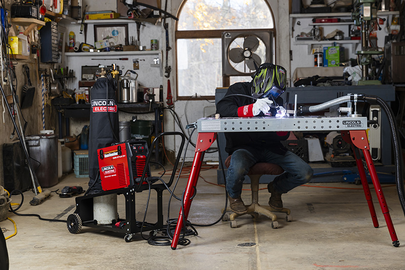 The 225i DV STICK WELDER in indoor use